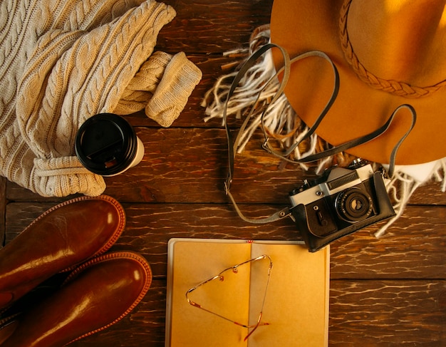 Autumn flat lay, hat, sweater, camera, coffee. cozy autumn