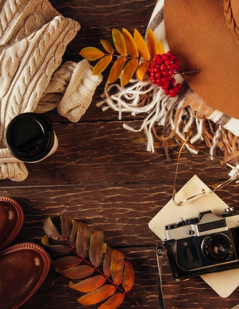 Autumn flat lay, hat, sweater, camera, coffee. cozy autumn