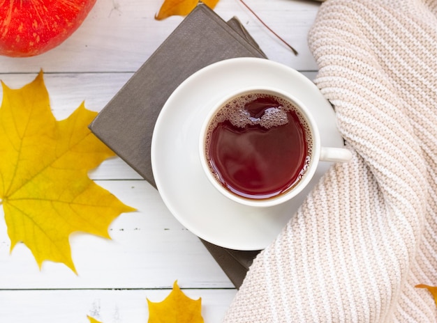 Autumn flatley a cup of tea yellow maple leaves books and a knitted thing