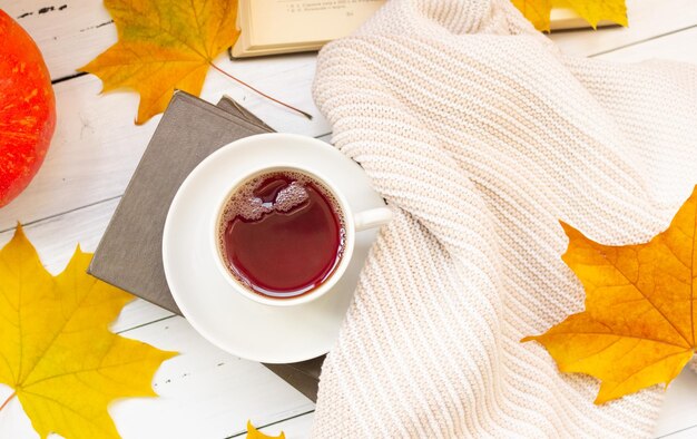 Autumn flatley a cup of tea yellow maple leaves books and a knitted thing