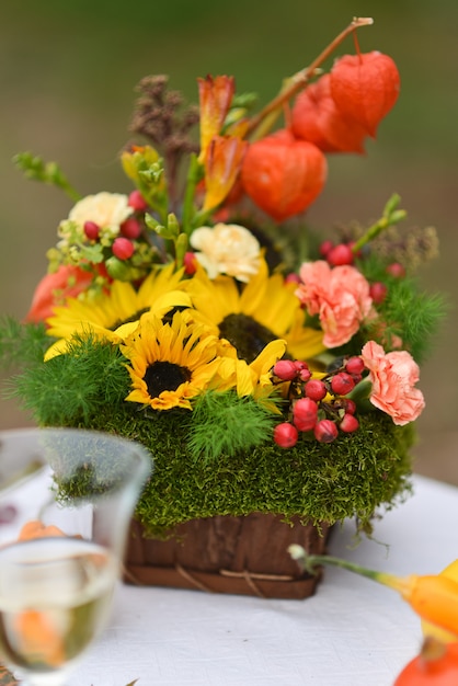 Autumn floral bouquet with sunflowers and physalis vase for Halloween 