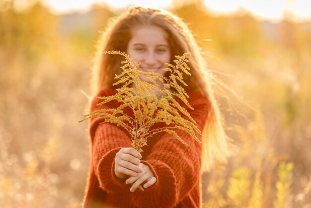Autumn flowers in young girl hands