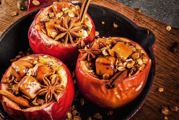 Autumn food recipes Baked apples stuffed with granola toffee and spices in frying pan