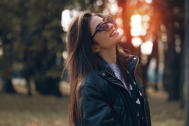 Autumn girl in black with sun shine