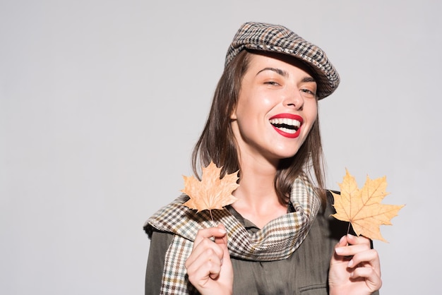 Autumn girl preparing for Autumn sale Sale for entire autumn collection incredible discounts and wonderful choice Surprise woman playing with leaves and looking at camera Autumn concept