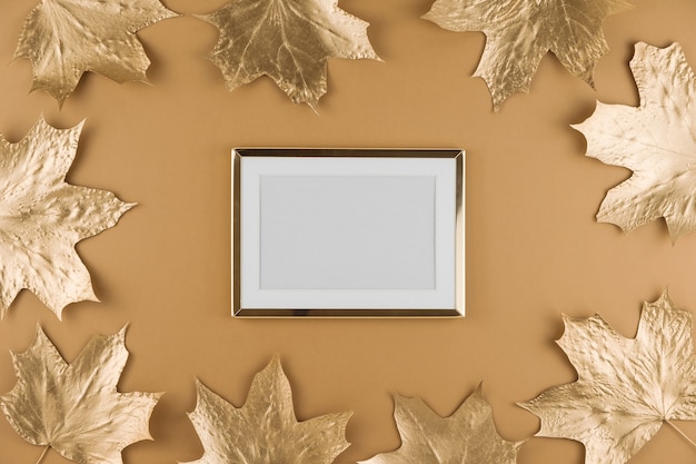 Autumn golden maple leaves and frame isolated on beige