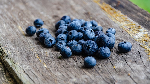 Autumn harvest of blueberries in the garden, lie on an old board.