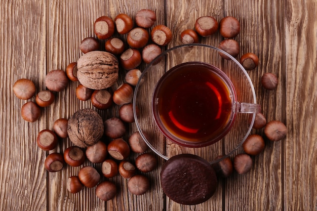 Autumn harvest. nuts on a dark recycled wood background, with copy space .. Top view of tea, nuts