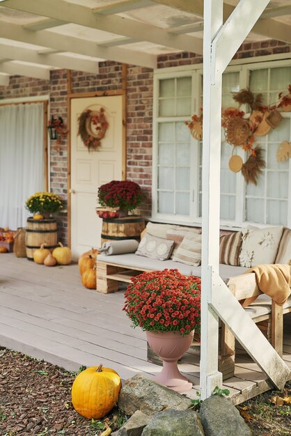 Autumn harvest terrace background. Halloween. Country. Pumpkins and flowers. Vacation home. Thanksgiving Day