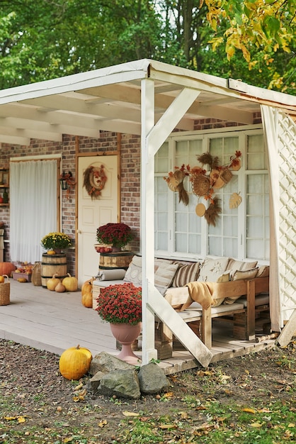 Autumn harvest terrace background. Halloween. Country. Pumpkins and flowers. Vacation home. Thanksgiving Day