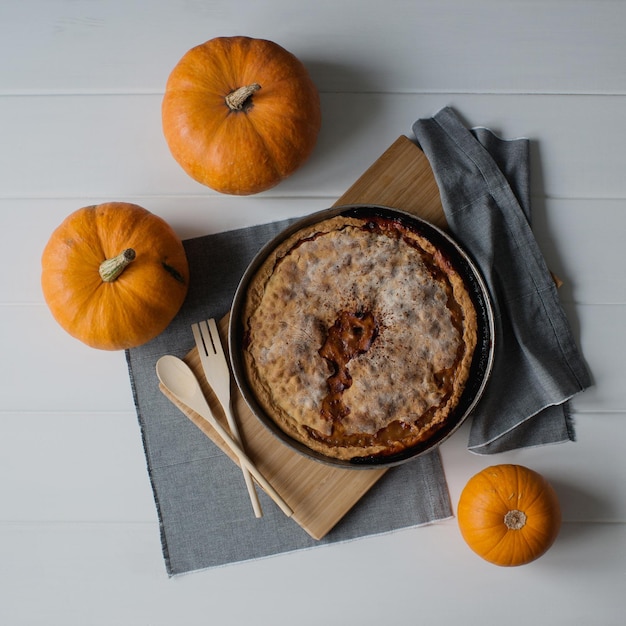 Autumn homemade pie with berries, pumpkins.