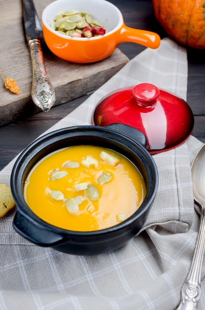 Autumn Homemade Pumpkin soup in clay bowl 