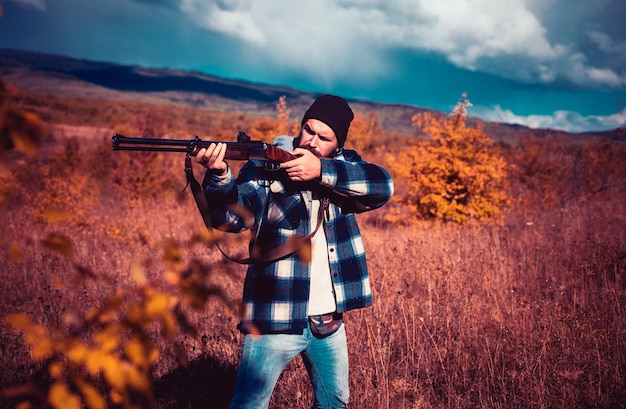 Autumn hunting season hunter with shotgun gun on hunt hunter with powerful rifle with scope spotting