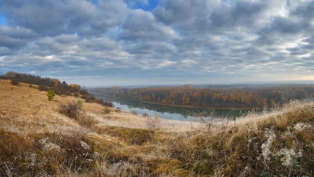 Autumn landscape on the hills of the River Don. View of the pond on a surface of cloudy sky ..