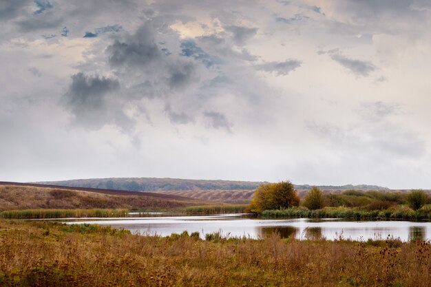 Autumn landscape with a river on the plain