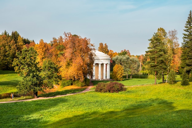 Autumn landscape with temple of Friendship is in Pavlovsk Park. St. Petersburg, Russia.