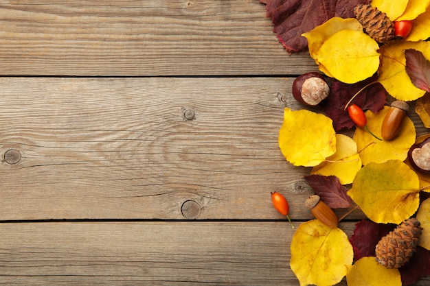 Autumn leaves on wooden background with copy space