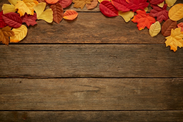 Autumn leaves on wooden background