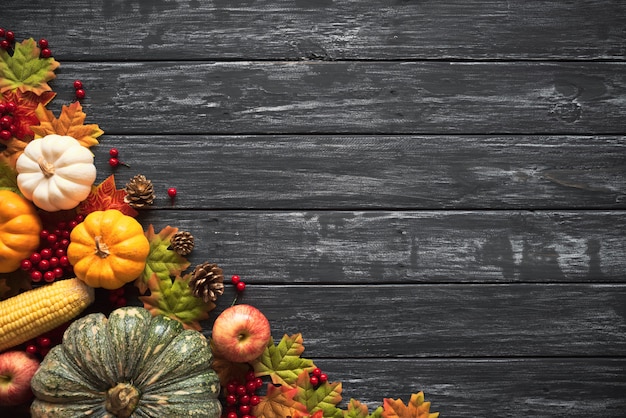 Autumn maple leaves with Pumpkin and red berries