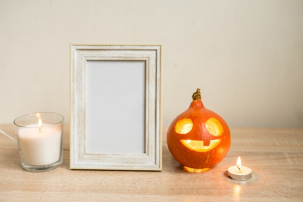 Autumn minimal composition. Thanksgiving holiday concept. Photo frame, pumpkin on white background. Front view, copy space . High quality photo