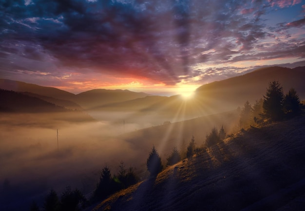 Autumn morning mountain landscape Sunrise over the fog