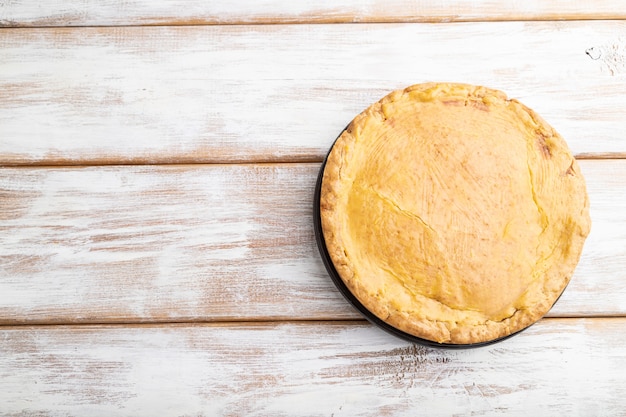 Torta e tazza di caffè della cipolla di autunno su legno bianco