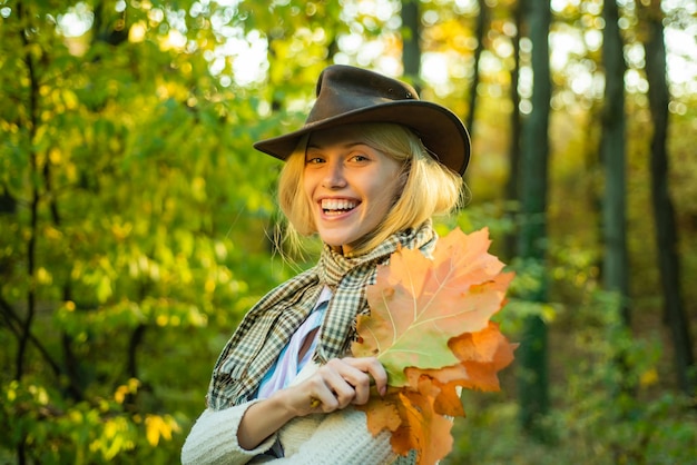 Autumn outdoor portrait of beautiful happy girl walking in park or forest Autumn woman with autumnal