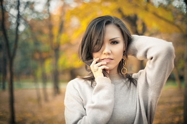 Autumn outdoor portrait of young beautiful mixed race woman 30 yo