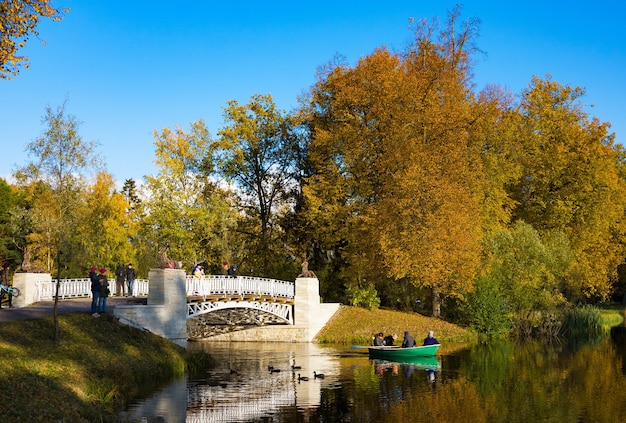 Autumn park, Slavyanka river and Cast-iron bridge in sunny day. Pavlovsk. St. Petersburg.