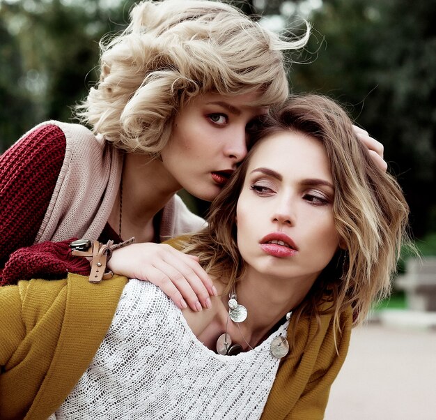 Autumn. Photo of a two beautiful women in the park.