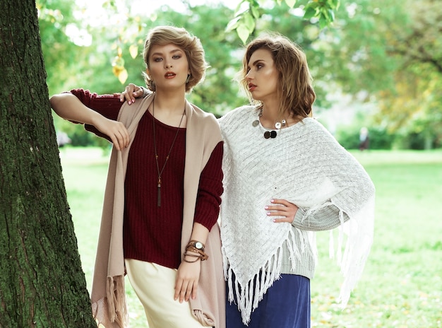 Autumn. Photo of a two beautiful women in the park.