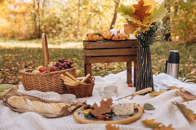 Autumn picnic Setting the table for the celebration Sweets in nature in the forest