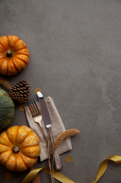 Autumn place setting lifestyle thanksgiving background with cutlery and pumpkins