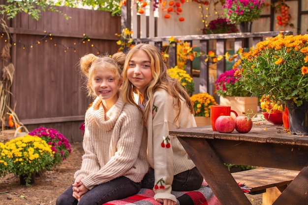 autumn portrait of a beautiful big friendly family in halloween near the house