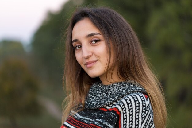 Autumn portrait of a girl in ethnic sweater