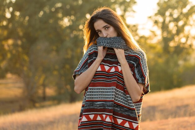 Autumn portrait of a girl in ethnic sweater