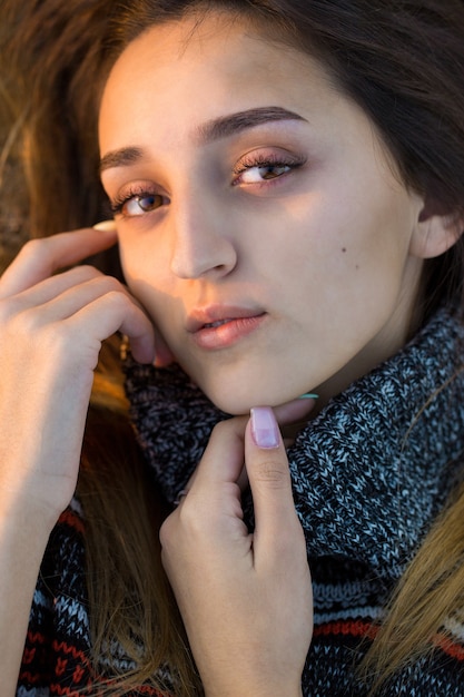 Autumn portrait of a girl in ethnic sweater