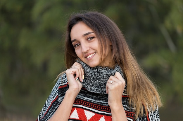 Autumn portrait of a girl in ethnic sweater