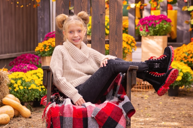 autumn portrait of happy cute schoolgirl girl in near home