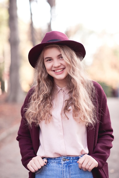 Autumn portrait of smiling blonde teenage girl wearing stylish jacket