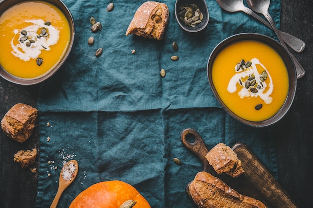 Autumn pumpkin creamy soup in bowls