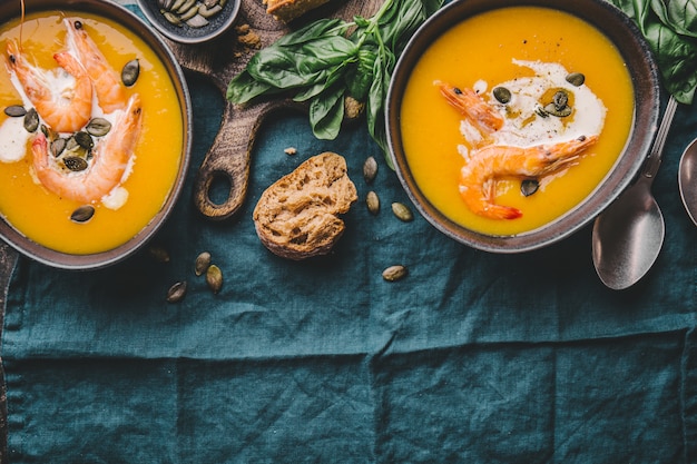 Autumn pumpkin creamy soup in bowls