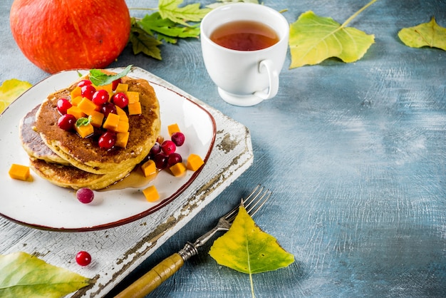 Autumn pumpkin pancakes with tea