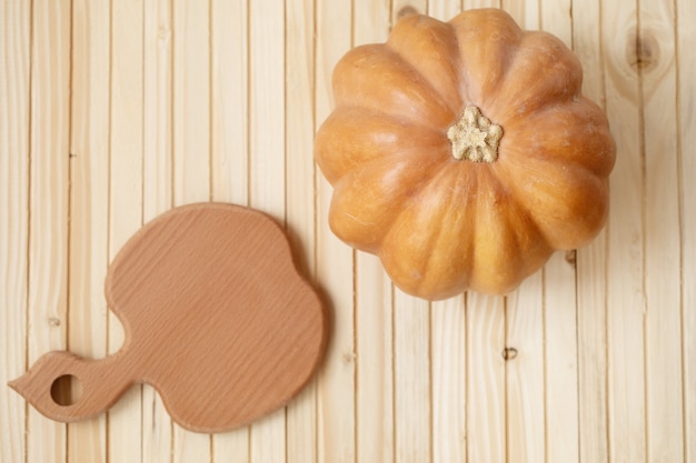 Autumn pumpkin on wooden board table