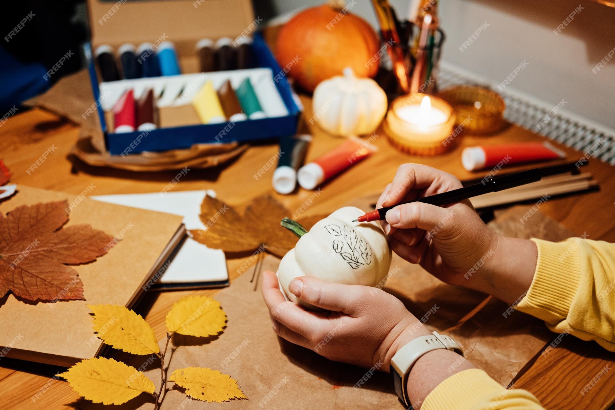 Premium Photo  Autumn pumpkins craft diy fall crafts for adults female  hands draw patterns on white pumpkin against