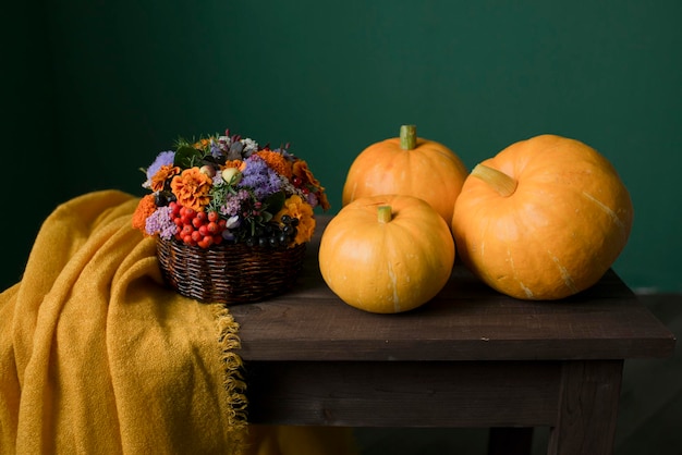 Autumn pumpkins and flowers on a wooden table