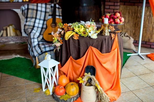 Autumn rural photozone beautiful autumn composition with\
pumpkins and leaves near wooden wall guitar orange cloth and\
pumpkins