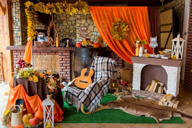 Autumn rural photozone. composition with pumpkins and leaves near wall.