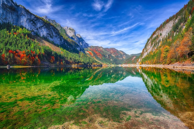 Autumn scenery with Dachstein mountain summit reflecting in crystal clear Gosausee mountain lake