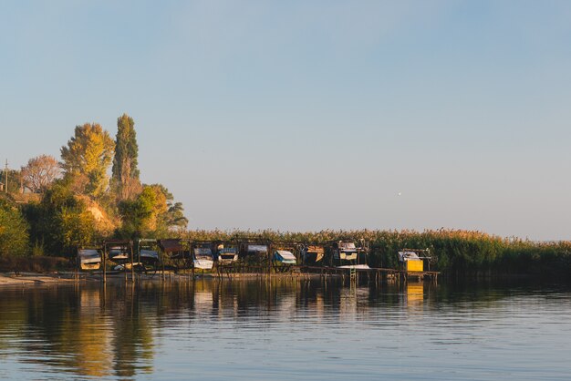 Autumn shore near the water near the boat